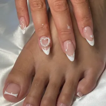 Almond French tips with a crystal heart, and matching French toes