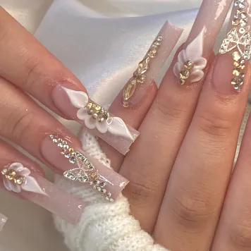 Long square nails with rhinestone butterflies and 3D flowers